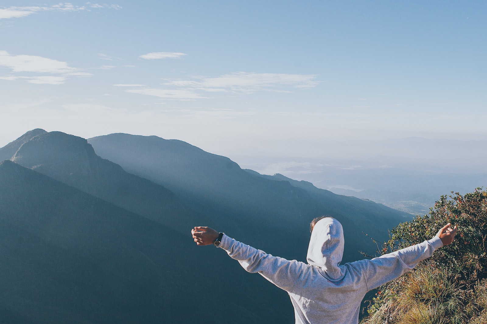 Person in White Long Sleeve Shirt Raising Both Hands