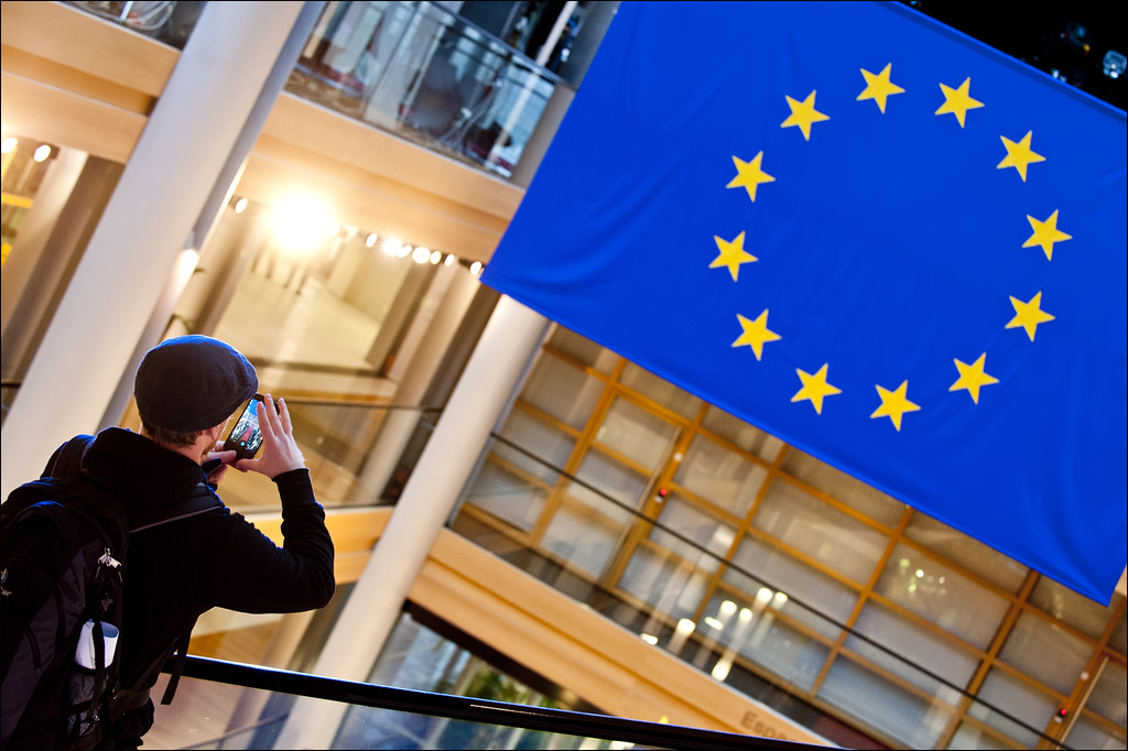 Traveler standing in front of a European flag